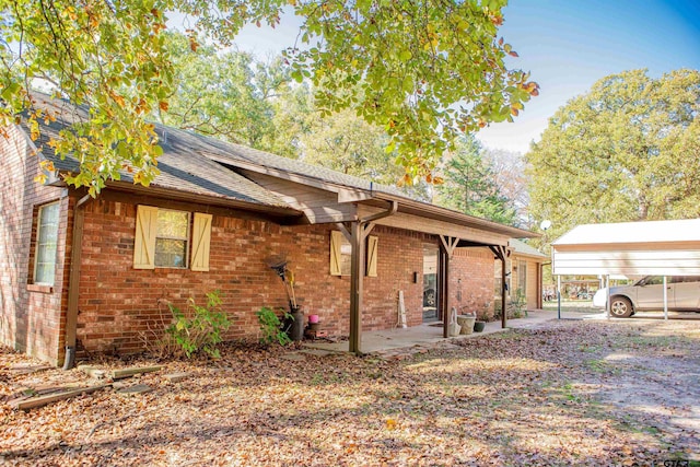 view of side of property with a carport