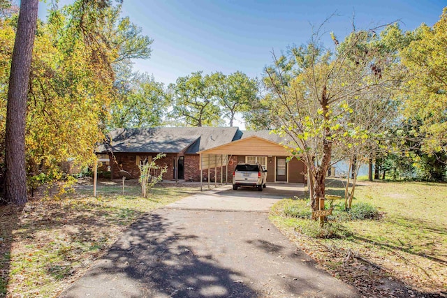 view of front of house with a front lawn and a carport