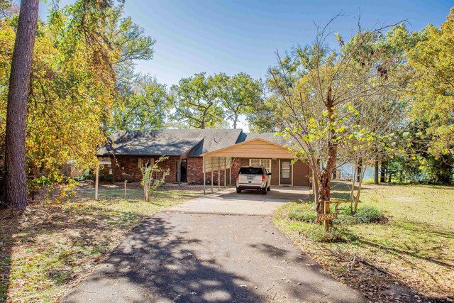 view of front of house with a front lawn and a carport