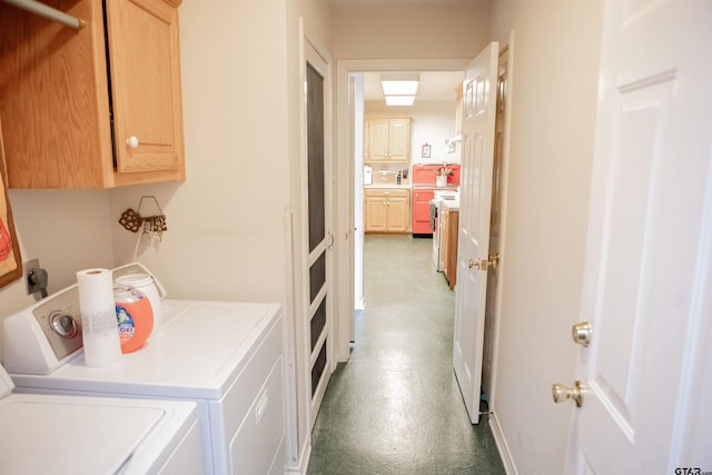 clothes washing area with cabinets and separate washer and dryer