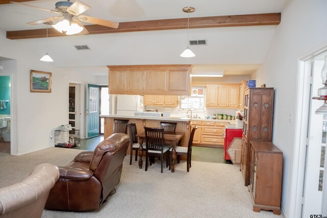 kitchen with a wealth of natural light, light carpet, and ceiling fan