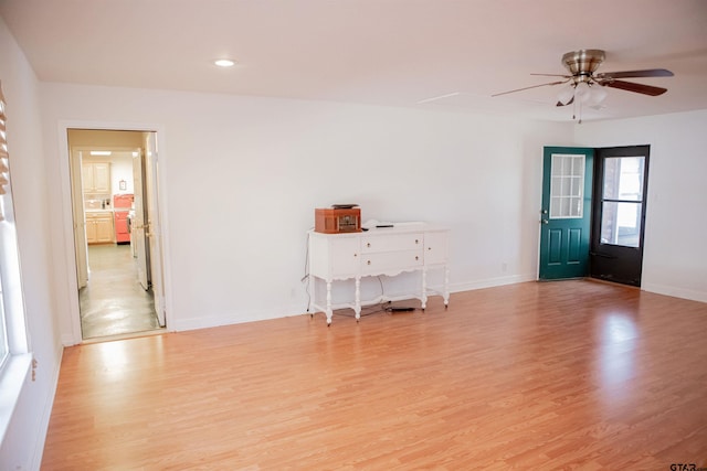 empty room featuring ceiling fan and light hardwood / wood-style flooring