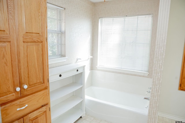 bathroom with a tub to relax in and tile patterned flooring