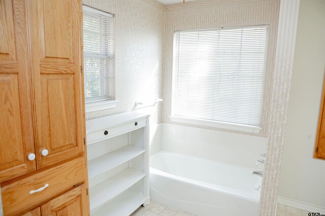 bathroom with a tub to relax in and tile patterned flooring