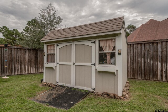 view of outdoor structure with a lawn