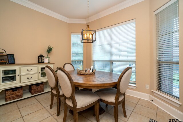 tiled dining area with a chandelier, a healthy amount of sunlight, and crown molding