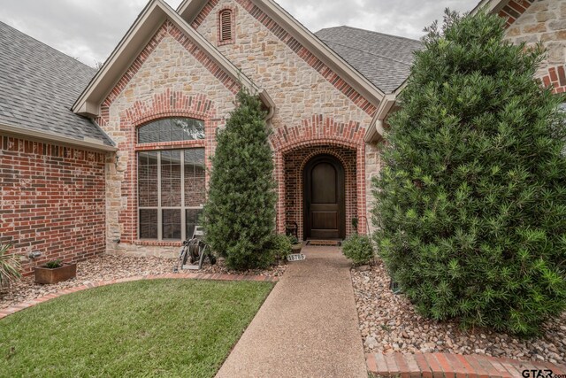 doorway to property featuring a yard