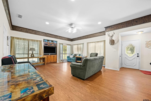 living room featuring wood-type flooring and ceiling fan