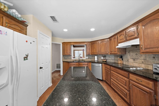 kitchen featuring black electric cooktop, white refrigerator, dishwasher, tasteful backsplash, and light hardwood / wood-style flooring