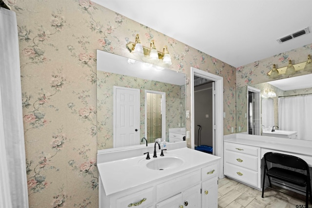 bathroom with vanity and hardwood / wood-style flooring