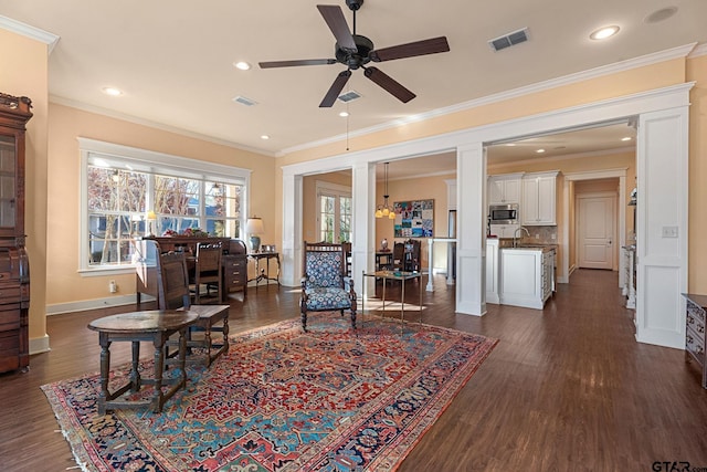 living room featuring sink, ceiling fan with notable chandelier, dark hardwood / wood-style flooring, and crown molding