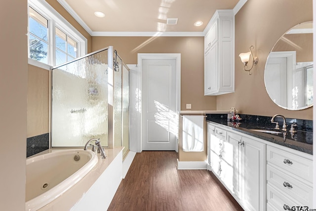 bathroom featuring wood-type flooring, vanity, independent shower and bath, and ornamental molding