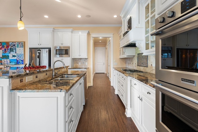 kitchen with decorative backsplash, sink, white cabinets, and appliances with stainless steel finishes