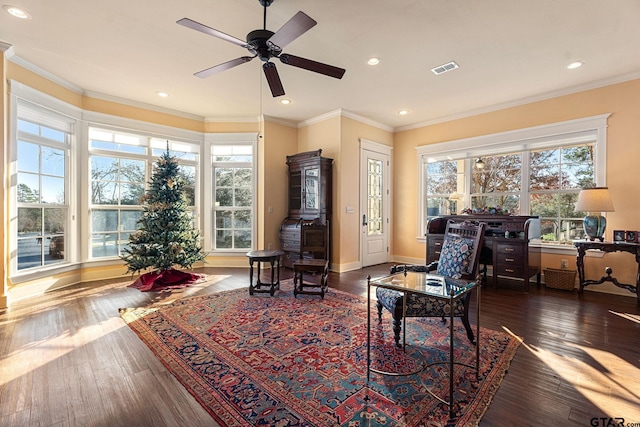 sitting room with dark hardwood / wood-style floors, ceiling fan, and crown molding