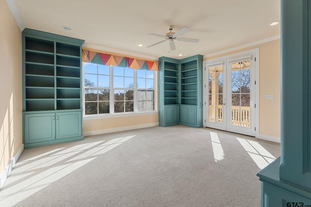 unfurnished room featuring ceiling fan, french doors, light colored carpet, and ornamental molding