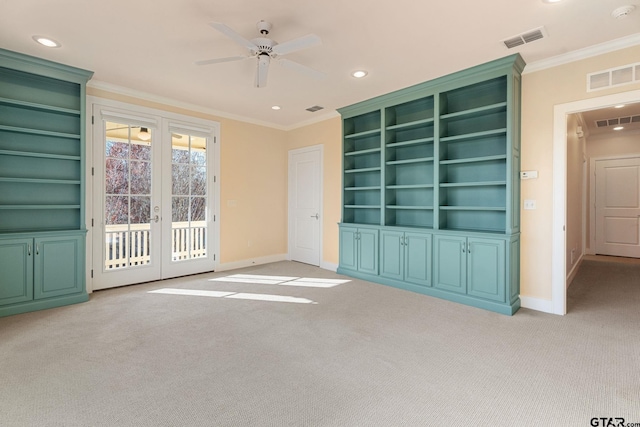 unfurnished living room featuring ornamental molding, light carpet, and french doors