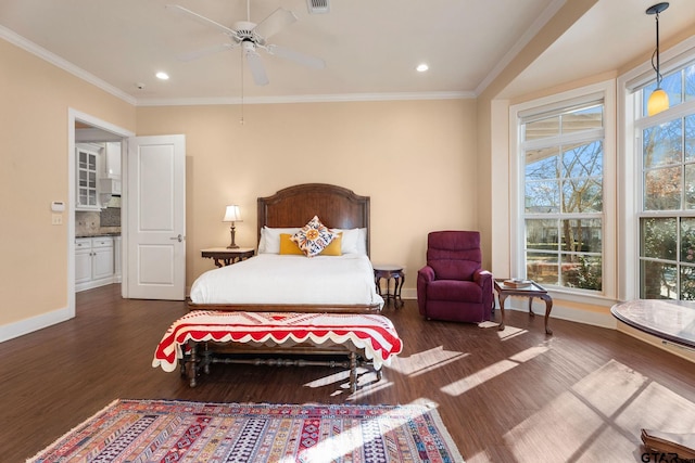 bedroom featuring connected bathroom, dark wood-type flooring, ceiling fan, and ornamental molding