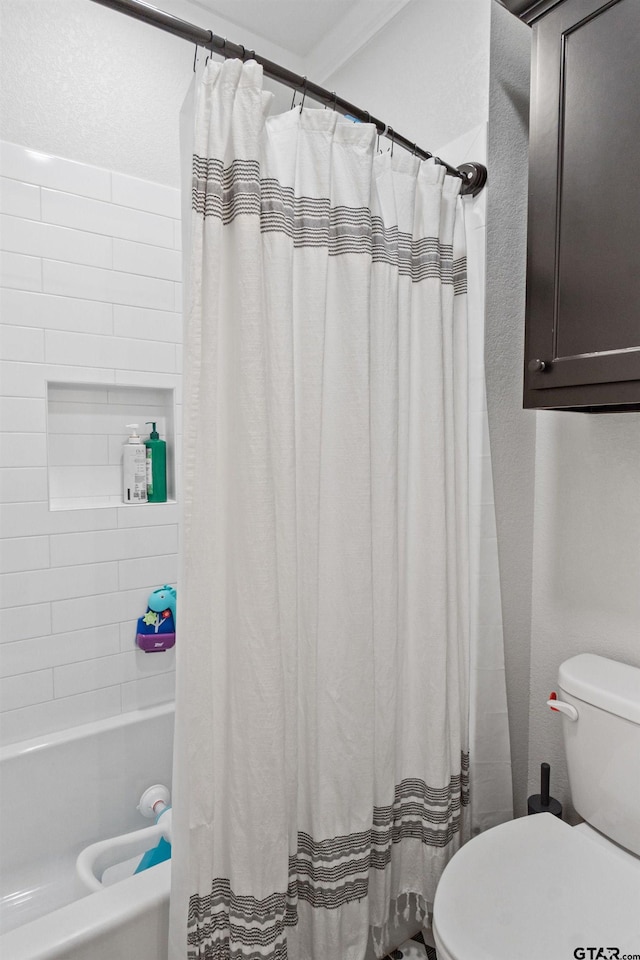 bathroom featuring toilet and shower / bath combination with curtain