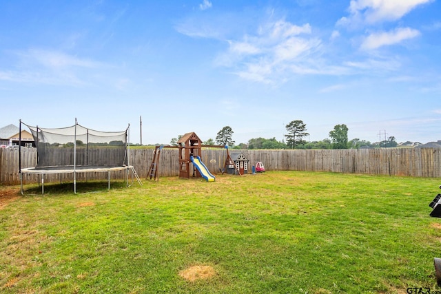 view of yard with a playground and a trampoline