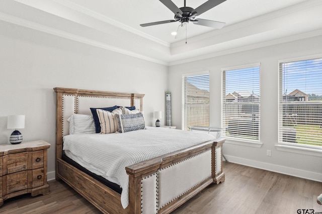 bedroom featuring dark wood-type flooring, multiple windows, and ceiling fan