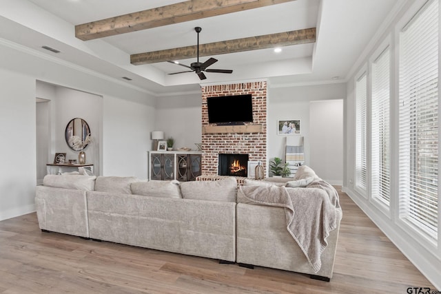 living room with a wealth of natural light and light hardwood / wood-style floors