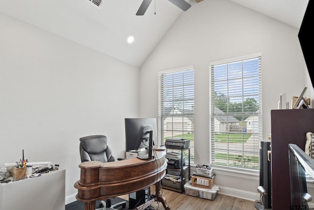 office space featuring high vaulted ceiling, light wood-type flooring, ceiling fan, and plenty of natural light