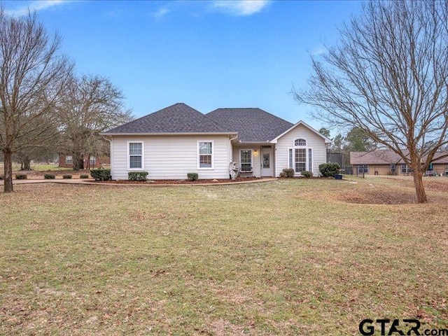 ranch-style home featuring a front yard