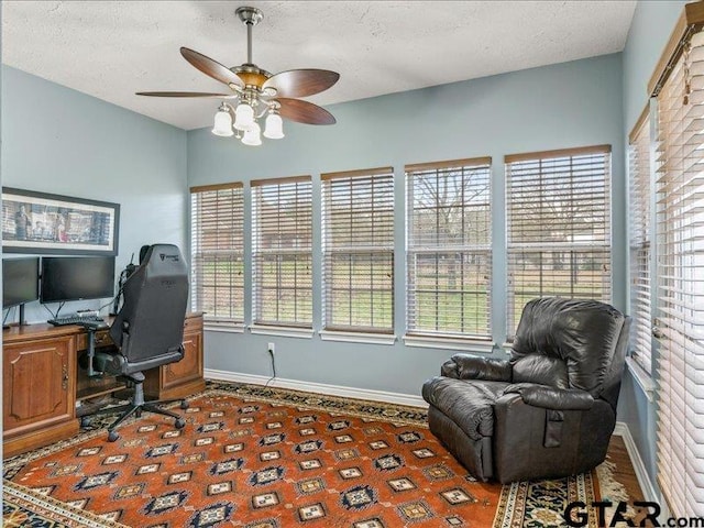 home office featuring a textured ceiling and ceiling fan