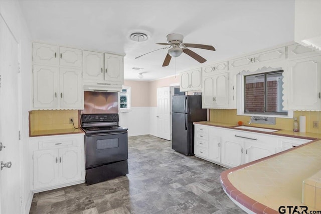 kitchen featuring a sink, white cabinetry, ceiling fan, under cabinet range hood, and black appliances