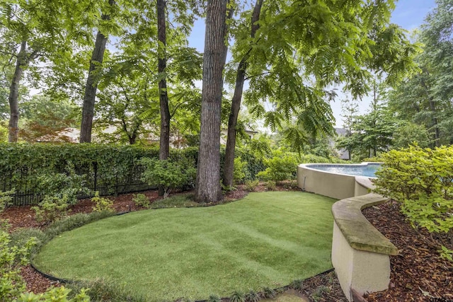 view of yard with an outdoor pool and fence