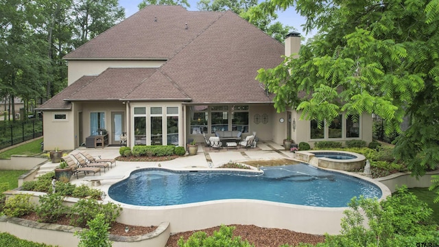 back of house featuring fence, a patio, stucco siding, a chimney, and a pool with connected hot tub