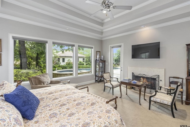 bedroom featuring carpet flooring, ceiling fan, a premium fireplace, access to exterior, and ornamental molding