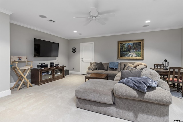living room featuring visible vents, a ceiling fan, baseboards, and ornamental molding