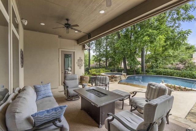 view of patio featuring a ceiling fan, an outdoor living space with a fire pit, and a pool with connected hot tub