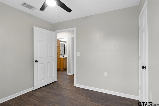 unfurnished bedroom featuring ceiling fan and dark hardwood / wood-style floors