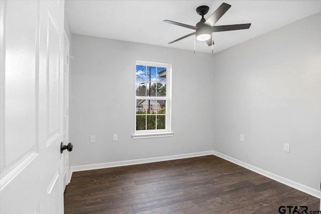 empty room with ceiling fan and dark hardwood / wood-style floors