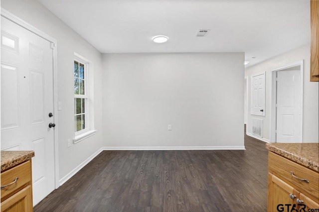 unfurnished dining area featuring dark hardwood / wood-style floors