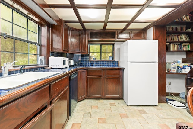 kitchen featuring white appliances, plenty of natural light, sink, and tasteful backsplash