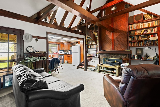 carpeted living room featuring a high end fireplace, high vaulted ceiling, wooden walls, and beam ceiling