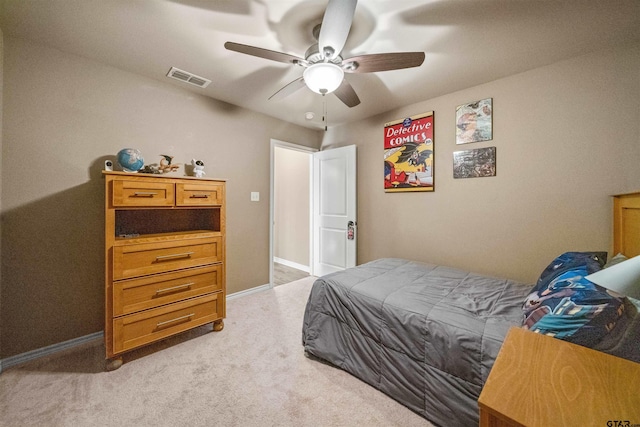 bedroom with visible vents, baseboards, light colored carpet, and a ceiling fan