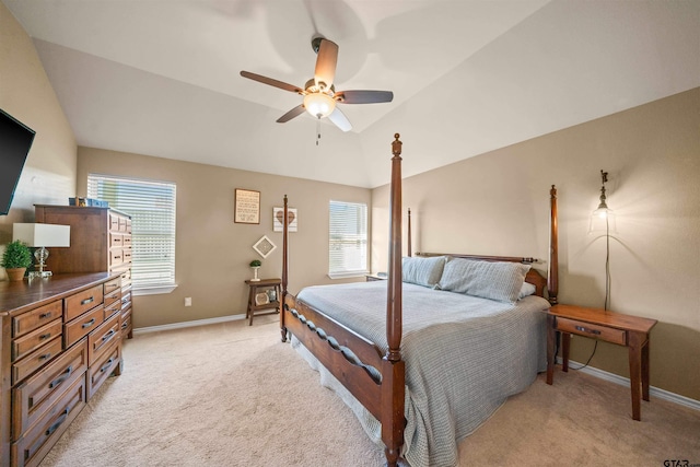 bedroom with light carpet, ceiling fan, baseboards, and lofted ceiling