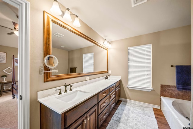 bathroom with double vanity, visible vents, and a sink