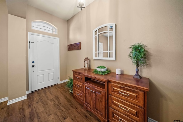 entrance foyer featuring dark wood finished floors and baseboards