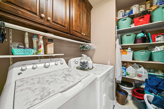 washroom with cabinet space and washing machine and dryer