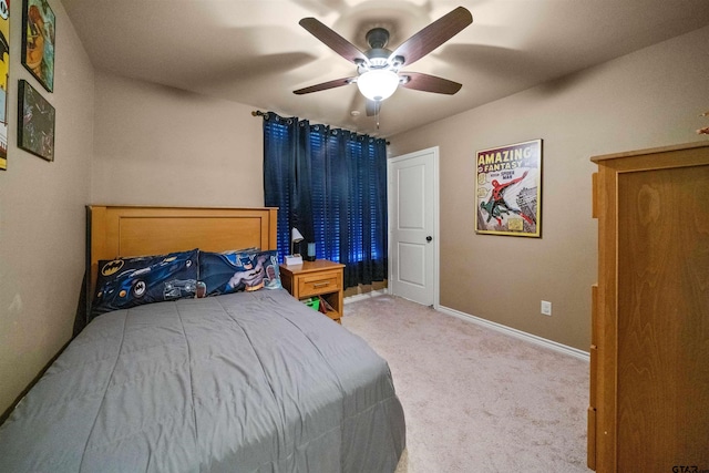 carpeted bedroom featuring baseboards and ceiling fan