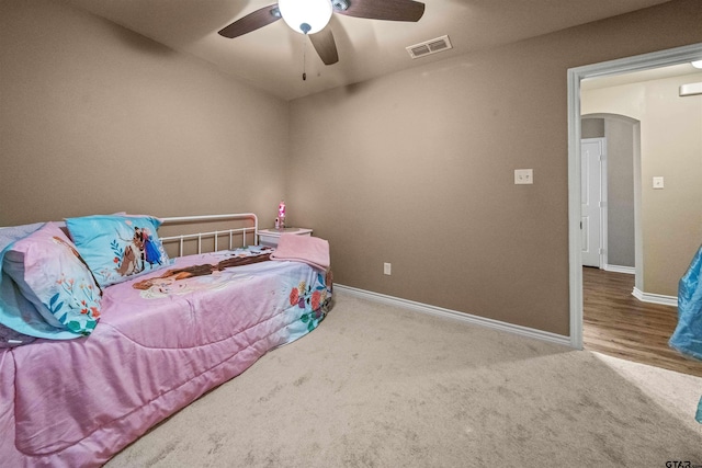 bedroom with visible vents, baseboards, a ceiling fan, and carpet flooring