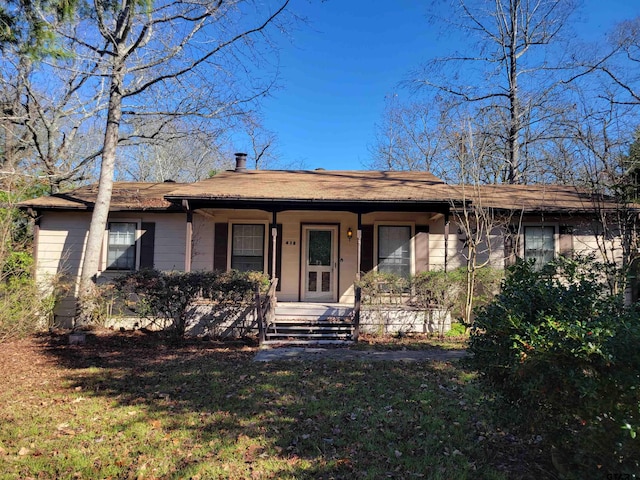 single story home with a front yard and a porch