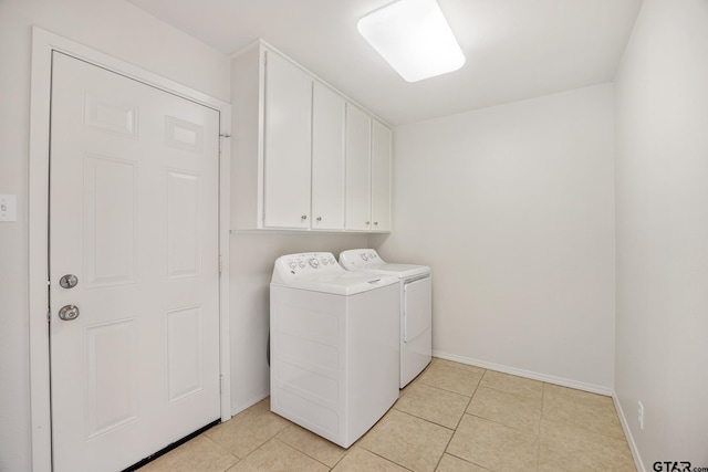 laundry room with cabinets, separate washer and dryer, and light tile patterned floors