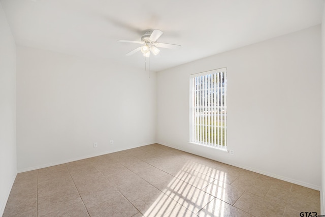 tiled empty room with ceiling fan