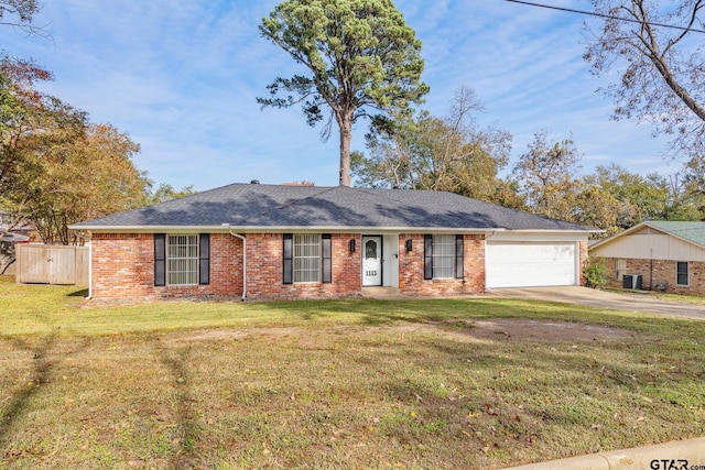 single story home featuring a front yard and a garage